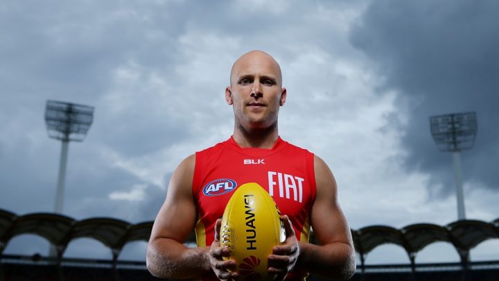 Gary Ablett Jr Australian AFL Player smooth bald head holding rugby ball