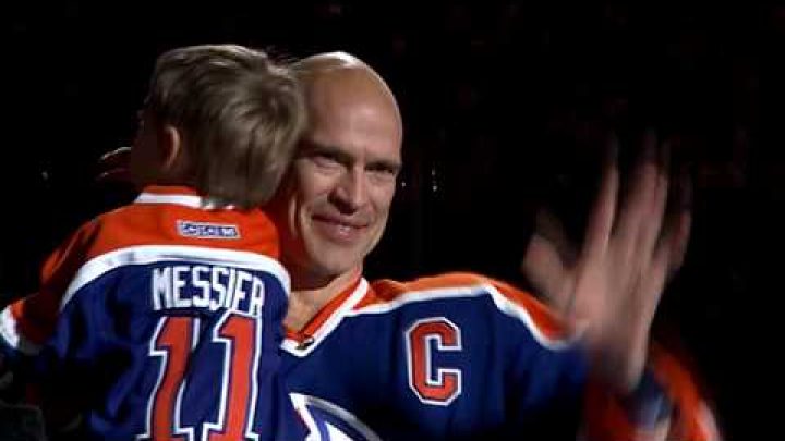 Mark Messier Canadian Ice Hockey Player bald head holding son and waving