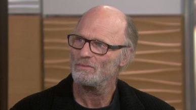 Ed Harris Bald Head wearing glasses with short grey beard